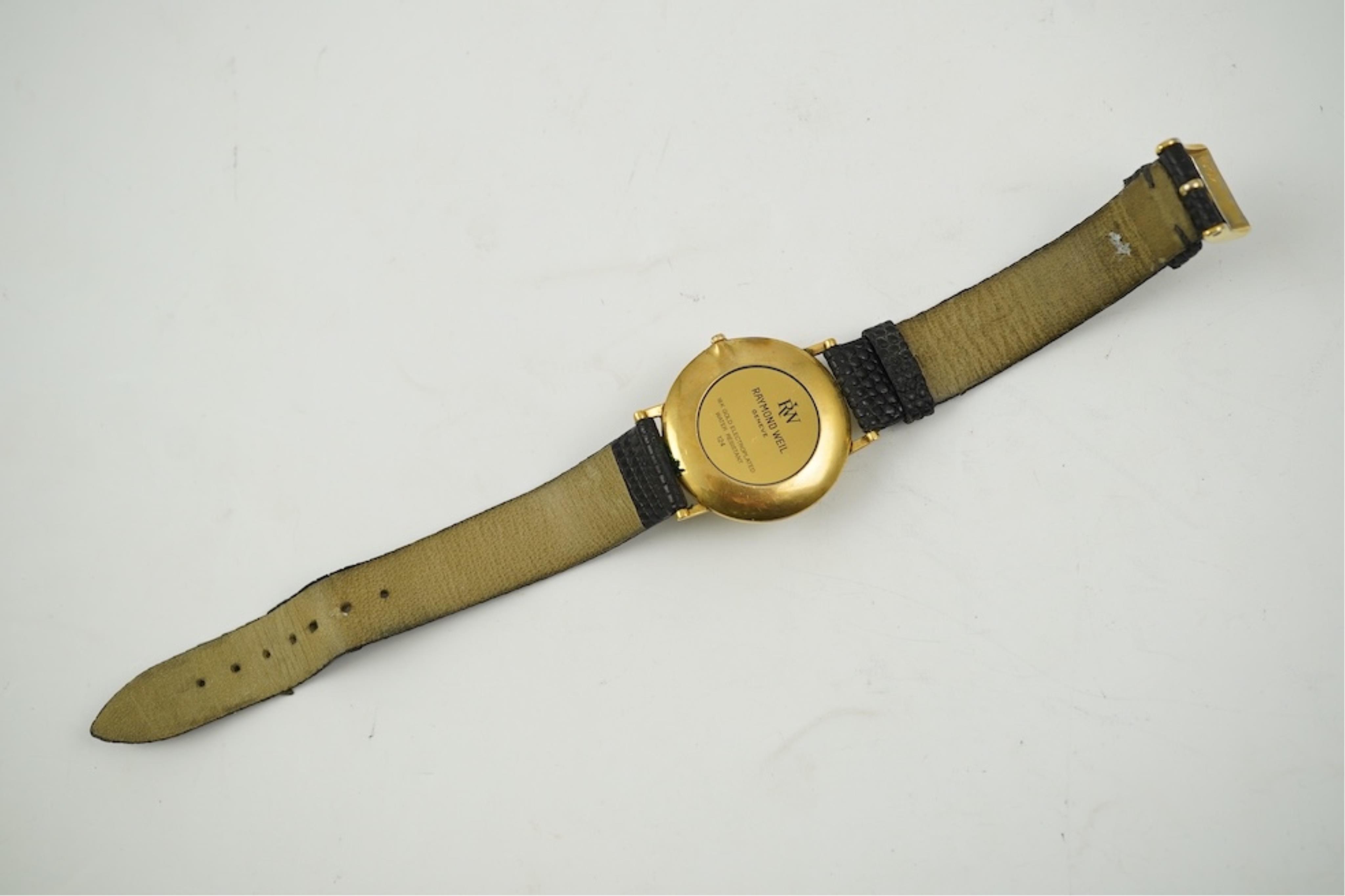 A gentleman's recent 18k gold electro-plated Raymond Weil quartz dress wrist watch, case diameter 33mm and a similar Gucci quartz dress wrist watch.